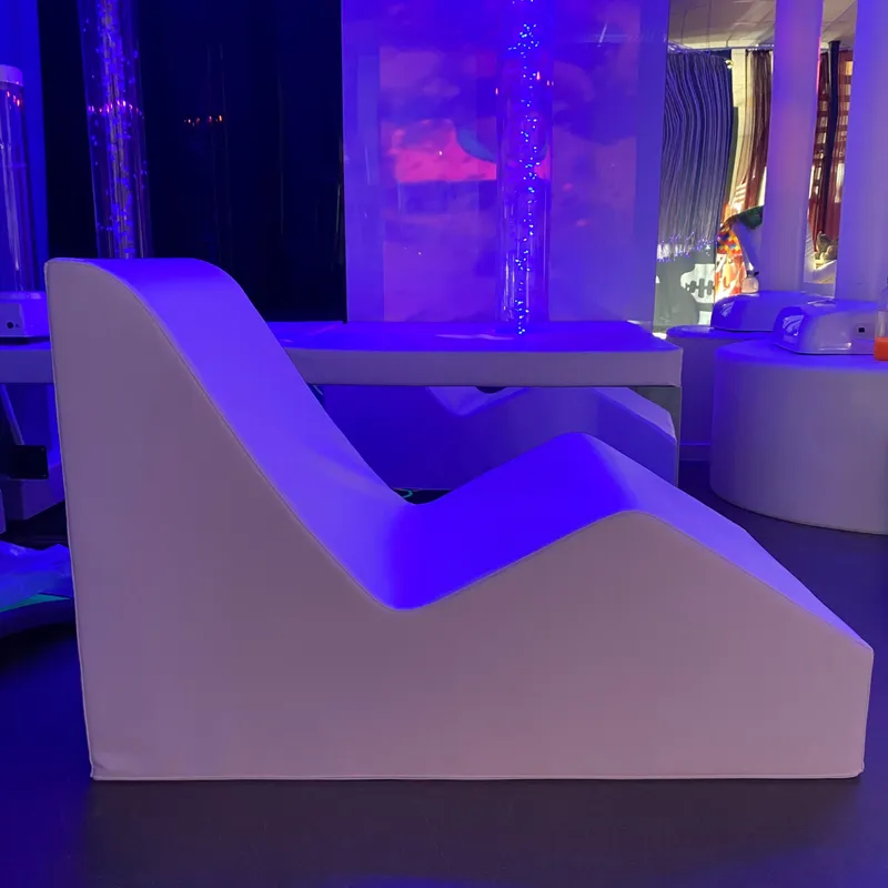 White curved chaise lounge in blue light