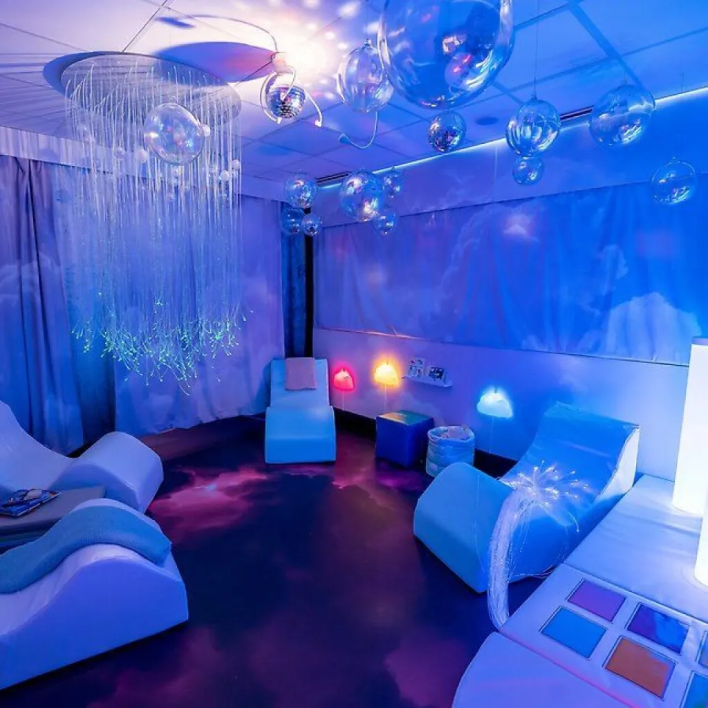 Blue-lit sensory room with fiber-optic lights