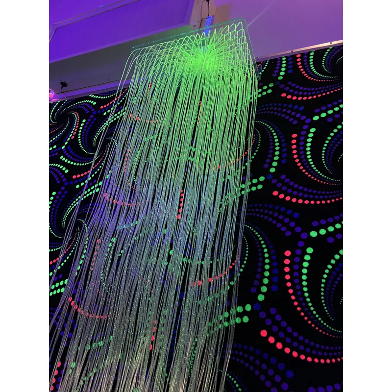 Fiber optic light installation with neon backdrop